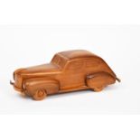 A novelty Italian Walnut car model, the roof hinged, opening to show cigarette and match holder, the