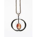 A Finnish silver pendant necklace, open circular frame set with central hardstone cabochon,