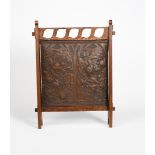 A Leatho oak and embossed leather firescreen, the rectangular panel embossed with Art Nouveau