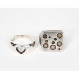 A Georg Jensen silver ring, square section, cast with circle design, and another Georg Jensen silver