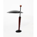 A modern table lamp, domed black enamel base supporting angled stem and flat domed shade,
