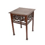 A carved oak table, square top, on square section legs, the under-tier carved with Classical