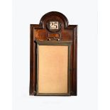 A mahogany wall calendar and notice board in the manner of C F A Voysey, rectangular with domed top,