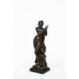 An Art Nouveau patinated bronze figure of Venus bathing, modelled standing gazing at a mirror, a