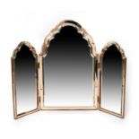 An Art Deco peach tinted glass triptych dressing table mirror, stepped, cloud top, the central large