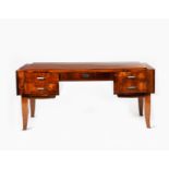 An Art Deco rosewood veneer desk, rectangular section on flaring legs, the top with shallow step