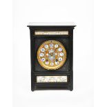 A large slate mantel clock by Wassell & Halford designed by Lewis F Day, rectangular with circular