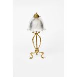 An Art Nouveau brass table lamp, tripod foot, central column, with fluted clear glass shade and a