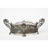 An Art Nouveau WMF electroplated metal and glass flower trough, oval section, cast with scrolling