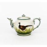 A Wemyss Pottery Pheasant teapot and cover, ovoid, painted with a bird walking before ferns, in
