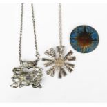 A Brutalist silver pendant necklace, cast textured form, another star-shaped pendant and a brooch