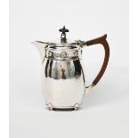 An A E Jones silver coffee pot, hammered finish on four flat disc feet, shouldered form with