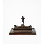 Omar Ramsden (1873-1939) Marco Polo, a patinated bronze double inkwell and cover, dated 1921,
