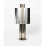 A large polished steel table lamp and shade, retailed by Heal's, disc base supporting four curved