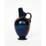 A Thomas Webb Bronze glass ewer the design attributed to Dr Christopher Dresser, ovoid, footed
