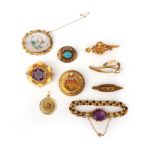 A group of nine gold and gem-set jewels, 19th century and later, comprising: a gold chain