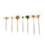 A collection of seven stick pins, early 20th century, comprising: one with a sycamore leaf in