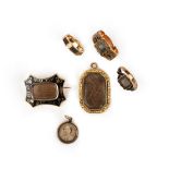 Six items of mourning jewellery, including a gold ring containing hair and decorated with black