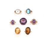 A group of seven gold and gem-set rings, comprising: three amethyst rings; two citrine rings; a
