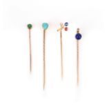 A collection of four gold and gem-set stick pins, late 19th century, comprising: one stick pin set