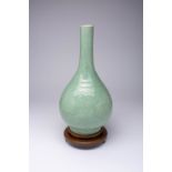 A LARGE CHINESE CARVED CELADON BOTTLE VASE, DANPING 18TH CENTURY The pear-shaped body surmounted