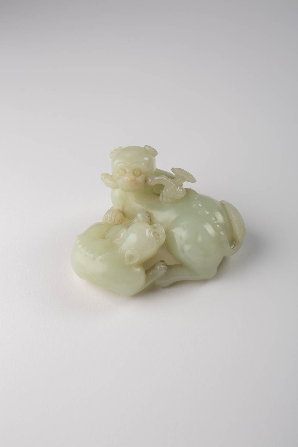A CHINESE PALE CELADON JADE LION DOG GROUP 19TH CENTURY Carved as a recumbent mother and pup, both - Image 2 of 2