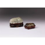 TWO CHINESE JADE CARVINGS OF RECUMBENT ANIMALS QING DYNASTY AND LATER One jadeite, carved as a