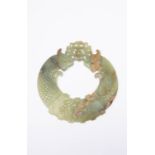 A CHINESE CELADON JADE HUAN LATE QING DYNASTY/REPUBLIC PERIOD Each side carved in shallow relief,