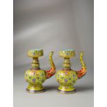 AN EXCEPTIONAL AND RARE PAIR OF CHINESE IMPERIAL YELLOW-GROUND TIBETAN STYLE EWERS, PENBA HU SIX