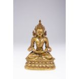 A CHINESE GILT-BRONZE SEATED BODHISATTVA 18TH CENTURY Wearing an elaborate headdress, sitting in