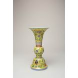 *A CHINESE FAMILLE ROSE YELLOW-GROUND GU-SHAPED 'BAJIXIANG' VASE SIX CHARACTER QIANLONG MARK BUT