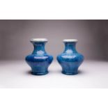 A NEAR PAIR OF CHINESE FLAMBE GLAZED VASES 18TH CENTURY Each with a compressed bulbous body raised