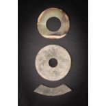 THREE CHINESE ARCHAIC JADES NEOLITHIC AND LATER Comprising: a bi disc incised on both sides with C-