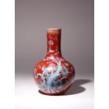 A CHINESE FAMILLE ROSE COPPER-RED GROUND BOTTLE VASE 19TH CENTURY Painted with four birds amidst