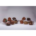 A COLLECTION OF ELEVEN CHINESE YIXING TEAPOTS AND COVERS 18TH CENTURY AND LATER Variously