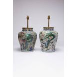 TWO CHINESE WUCAI 'DRAGON' AND 'DRAGON AND PHOENIX' JARS 17TH CENTURY Each painted with two pairs of