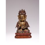 A CHINESE PARCEL-GILT BRONZE FIGURE OF GUANYIN MING DYNASTY The bodhisattva seated in dhyanasana