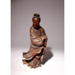 A CHINESE CARVED AND LACQUERED WOOD FIGURE OF GUANYIN QING DYNASTY Standing, wearing long flowing