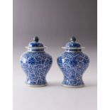 A PAIR OF CHINESE BLUE AND WHITE BALUSTER VASES AND COVERS 19TH CENTURY Each painted with stylised