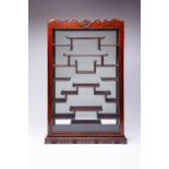 A HARDWOOD SNUFF BOTTLE DISPLAY CABINET 20TH CENTURY With a single glazed door enclosing an
