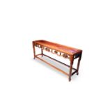 A LONG CHINESE HARDWOOD LOW TABLE QING DYNASTY The top set within a rectangular frame, above a