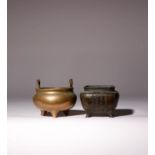 TWO CHINESE BRONZE INCENSE BURNERS QING DYNASTY One raised on three tapering feet, set with two