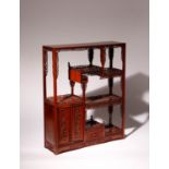 A CHINESE HARDWOOD DISPLAY STAND 20TH CENTURY With two hinged doors and a drawer to the lower