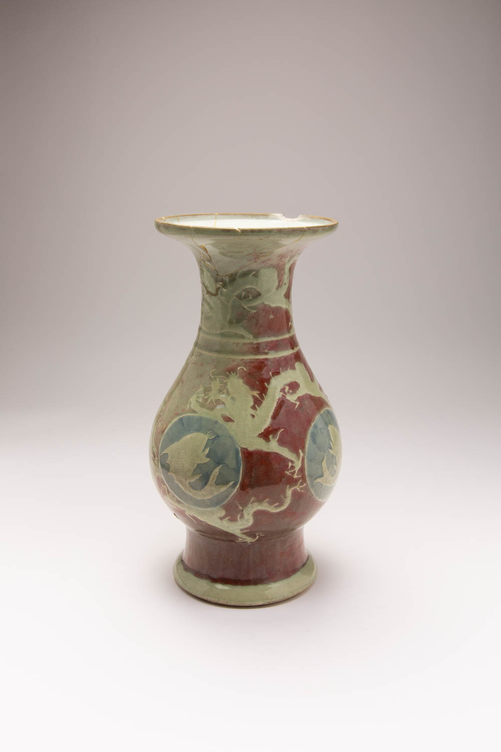 A CHINESE COPPER-RED GROUND, CELADON AND UNDERGLAZE BLUE BALUSTER VASE 18TH CENTURY The body