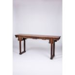 A CHINESE HARDWOOD SCROLL TABLE LATE QING DYNASTY The long rectangular top above a frieze, carved in