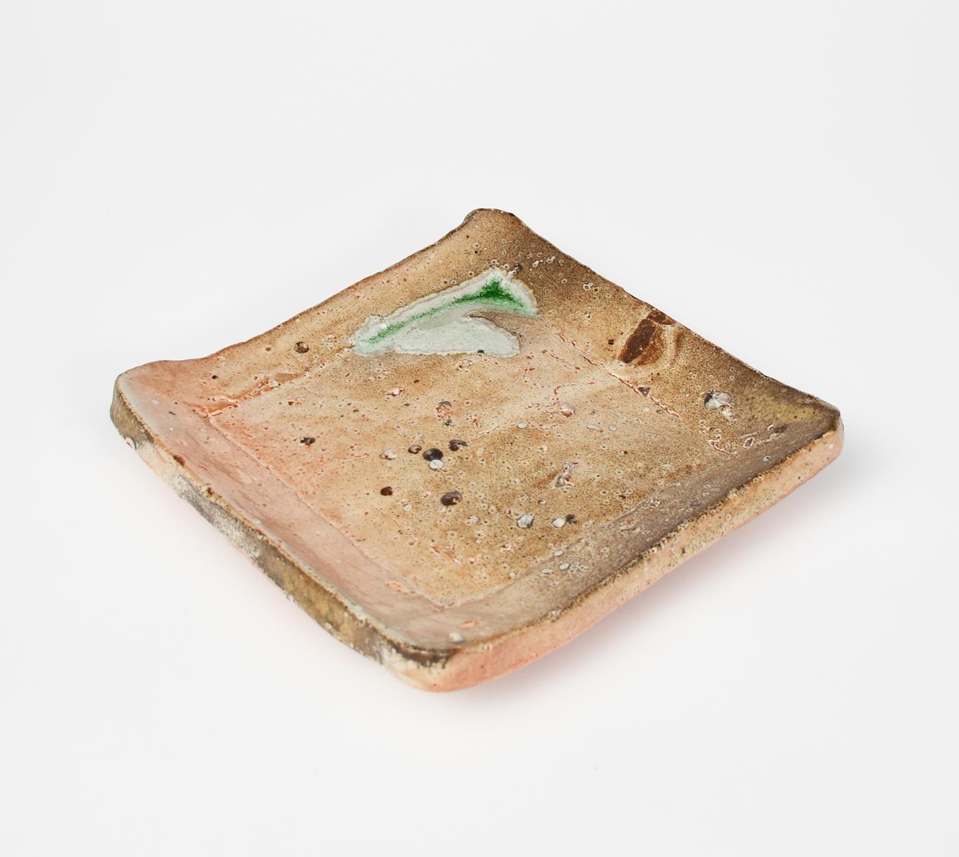 Nic Collins (born 1958) a salt-glaze stoneware dish, square section on four fleet, with pooled green