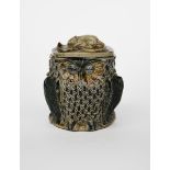 An early Martin Brothers stoneware Owl jar and cover by Robert Wallace Martin, dated 1877,
