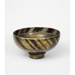 Sutton Taylor (born 1943) large footed bowl, lustre decorated with bands of chevron motif in ruby