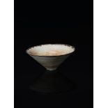 Dame Lucie Rie DBE 1902-1995) a porcelain bowl, flaring conical form, covered in a pitted mint