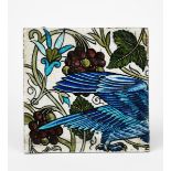 A William De Morgan Persian tile, part of a panel, painted with the rear section of a blue bird,